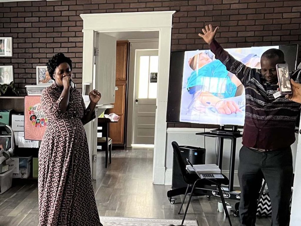 A woman sings while a man dances.