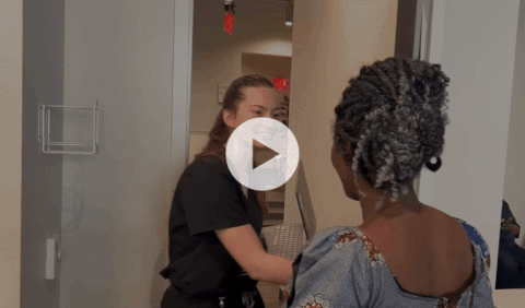 A video clip of a patient walking to an exam room with an employee at the Peace Project.