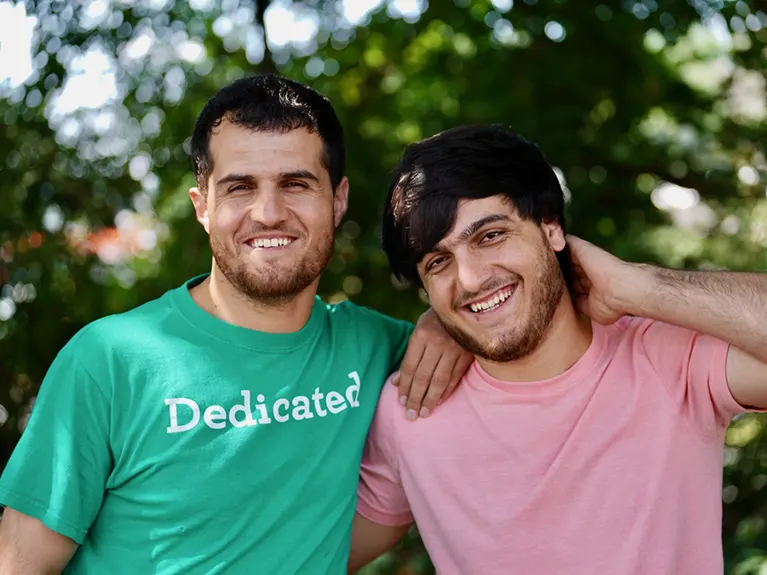 A Family Job class volunteer and student pose outside for a photo.