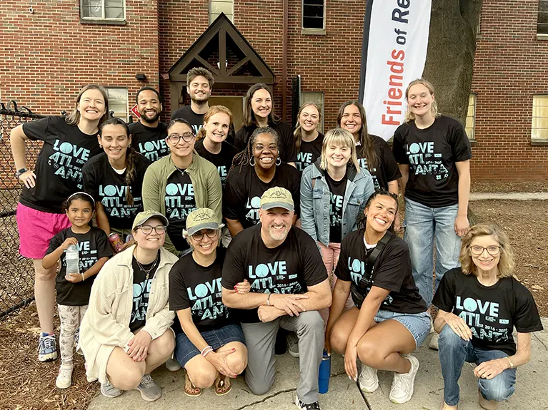 A group of volunteers pose for a photo.