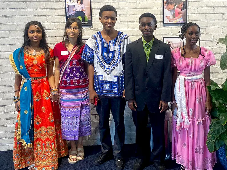 Five members of the the Growing Leaders program poses for a photo at a celebration event.