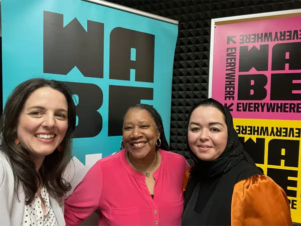 Rose Scott, the host of WABE's Closer Look, poses with Embrace Refugee Birth employees, Muzhda Oriakhil and Virginia Tester.