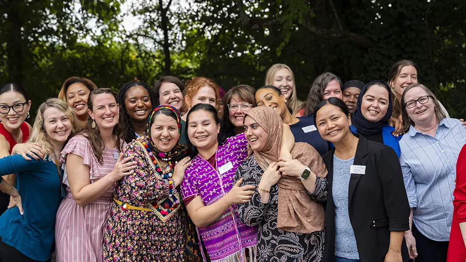 Friends of refugees staff members stand outside for a group photo.