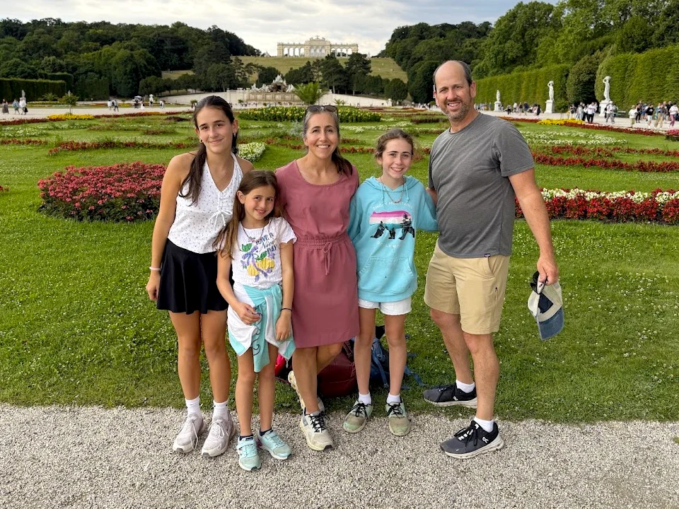 The Kipfer family pose for a photo in a large decorative garden.